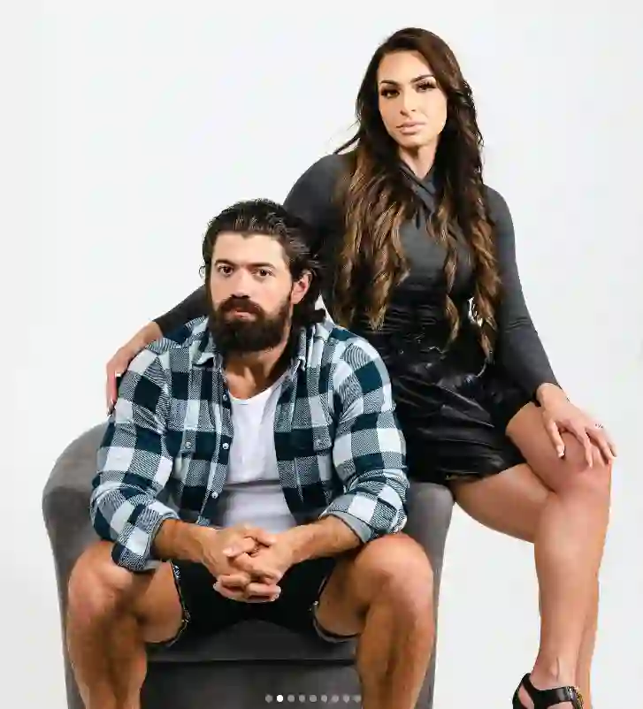 An Instagram photo featuring Alex Hormozi and his wife Leila Hormozi sitting together.